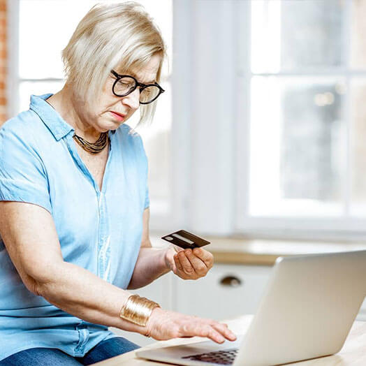 Lady entering her debit card number online.